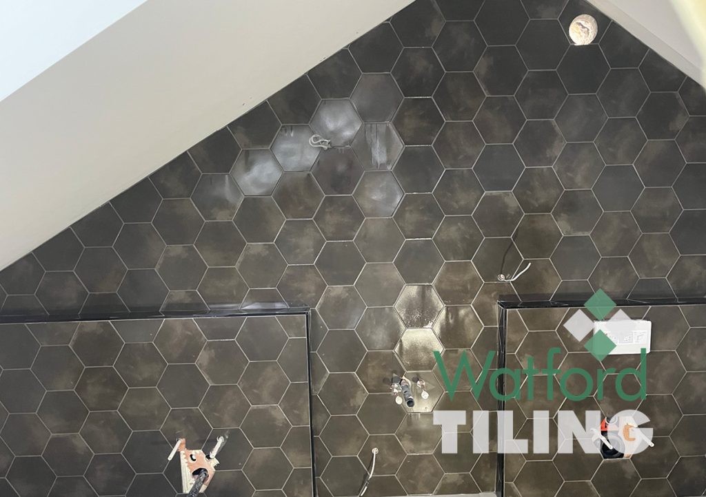 Floor to ceiling geometric tile design, fitting into coom ceiling by Watford Tiling